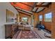 Spacious living room boasting wood paneling, high ceilings, and ample natural light with workout space at 26085 Amy Cir, Conifer, CO 80433