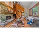 Cozy living room featuring a stone fireplace, hardwood floors, and comfortable seating for relaxation at 26085 Amy Cir, Conifer, CO 80433