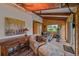 Relaxing sun room features exercise equipment, wood ceilings, and a vintage-style brick floor at 26085 Amy Cir, Conifer, CO 80433