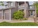 Charming home featuring stone pillars and walkway, complemented by lush landscaping and a welcoming entrance at 10230 Lauren Ct, Highlands Ranch, CO 80130