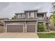 Two-story home featuring a two-car garage, stone accents, and a second story balcony at 10230 Lauren Ct, Highlands Ranch, CO 80130