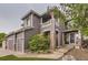Charming home featuring stone pillars and walkway, complemented by lush landscaping and a welcoming entrance at 10230 Lauren Ct, Highlands Ranch, CO 80130
