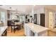Open-concept kitchen with a center island, stainless steel refrigerator, and adjacent living area at 10230 Lauren Ct, Highlands Ranch, CO 80130