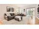 Cozy living room with large windows, sliding door, plush seating, and carpeted floors at 10230 Lauren Ct, Highlands Ranch, CO 80130