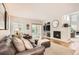 Comfortable living room featuring a fireplace, large windows and sliding door access to backyard at 10230 Lauren Ct, Highlands Ranch, CO 80130