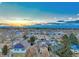 Beautiful aerial view of a tranquil neighborhood with Denver skyline and stunning mountain backdrop at sunrise at 3550 Eudora St, Denver, CO 80207