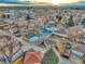 Expansive aerial view of the neighborhood showcasing rooftops and distant city skyline at sunset at 3550 Eudora St, Denver, CO 80207
