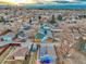 Expansive aerial view of a quiet neighborhood with Denver skyline and the Rocky Mountains in the distance at 3550 Eudora St, Denver, CO 80207