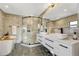 Luxurious bathroom featuring a glass shower, freestanding tub, double vanity, and elegant tile work at 3550 Eudora St, Denver, CO 80207