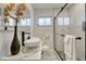 Modern bathroom with a vessel sink, decorative mirror, tiled walls and a glass-enclosed shower at 3550 Eudora St, Denver, CO 80207