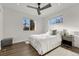 Bright bedroom featuring hardwood floors, large windows, and a modern ceiling fan at 3550 Eudora St, Denver, CO 80207