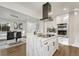 Bright, modern kitchen with island, stainless steel appliances, and sleek white cabinetry at 3550 Eudora St, Denver, CO 80207