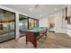 Well-lit recreation room featuring a pool table and access to outdoor entertainment areas at 3550 Eudora St, Denver, CO 80207
