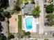 Overhead shot of community's pool, playground, and parking amidst green landscape, offering amenities at 12132 Huron St # 203, Denver, CO 80234