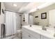 Bright bathroom featuring a double sink vanity, subway tile shower and tub, and neutral color palette at 12132 Huron St # 203, Denver, CO 80234