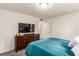 Bedroom features neutral walls, a large TV and a dresser at 12132 Huron St # 203, Denver, CO 80234
