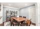 Elegant dining room featuring a wooden table with seating for six and stylish shelving at 12132 Huron St # 203, Denver, CO 80234