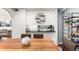 View of a dining room with a wooden table next to a modern kitchen countertop at 12132 Huron St # 203, Denver, CO 80234