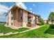 Exterior angle of the condo featuring brick and siding, balconies, and green lawn space at 12132 Huron St # 203, Denver, CO 80234