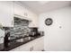 Kitchen with black countertops, mosaic backsplash and stainless steel sink at 12132 Huron St # 203, Denver, CO 80234