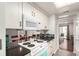 Galley-style kitchen featuring white cabinets and granite countertops at 12132 Huron St # 203, Denver, CO 80234