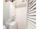 Efficient laundry area showcasing a stacked washer and dryer setup with storage shelves at 12132 Huron St # 203, Denver, CO 80234