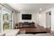 Modern living room featuring an electric fireplace, a large TV, and access to the balcony at 12132 Huron St # 203, Denver, CO 80234