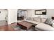 Inviting living room with an open concept dining area, hardwood floors, and comfortable seating at 12132 Huron St # 203, Denver, CO 80234