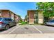 Designated parking spaces with a view of the brick and siding apartment buildings and manicured green spaces at 12132 Huron St # 203, Denver, CO 80234