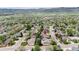 Beautiful aerial view of a neighborhood showcasing a home with mature trees, manicured lawns, and mountain scenery at 6386 S Pierson St, Littleton, CO 80127