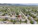 Panoramic aerial view of a well-established neighborhood, lush landscapes, and scenic mountain views in the distance at 6386 S Pierson St, Littleton, CO 80127