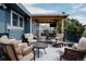 Inviting back deck featuring cushioned seating and an outdoor dining area with a mounted television at 6386 S Pierson St, Littleton, CO 80127