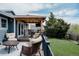 Inviting back deck featuring cushioned seating, outdoor dining area, and a view of the landscaped backyard at 6386 S Pierson St, Littleton, CO 80127