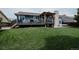 Expansive backyard with a lush green lawn, a charming deck, and an inviting outdoor living space at 6386 S Pierson St, Littleton, CO 80127