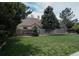 Serene backyard with a tall wooden fence, a sprawling green lawn, and mature trees for added privacy at 6386 S Pierson St, Littleton, CO 80127