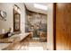 Luxurious bathroom with a large shower with stone-look ceramic tile and granite countertops at 6386 S Pierson St, Littleton, CO 80127