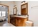 Spacious ensuite bathroom featuring double sinks, granite countertops, and wood cabinets at 6386 S Pierson St, Littleton, CO 80127