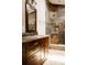 Bathroom with wood cabinets, granite counters, vessel sink, and stylish shower at 6386 S Pierson St, Littleton, CO 80127