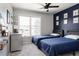 Comfortable bedroom with large window, accent wall, and two twin beds at 6386 S Pierson St, Littleton, CO 80127