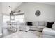 Open-concept dining area, adjacent to the living room, features a modern chandelier and large windows at 6386 S Pierson St, Littleton, CO 80127