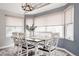 Bright and airy dining room features an elegant chandelier, a farmhouse-style table, and natural light at 6386 S Pierson St, Littleton, CO 80127