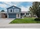 Charming two-story home features a well-manicured lawn, attached garage, and classic blue siding at 6386 S Pierson St, Littleton, CO 80127