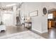 Bright and inviting foyer features stylish decor, hardwood floors, and a staircase leading to the upper level at 6386 S Pierson St, Littleton, CO 80127