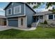 Charming two-story home with an attached garage, updated siding, and a well-maintained front yard at 6386 S Pierson St, Littleton, CO 80127