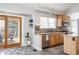 Updated kitchen featuring stainless steel appliances and a sliding door to a private deck at 6386 S Pierson St, Littleton, CO 80127