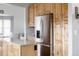 Updated kitchen featuring a stainless steel refrigerator and natural wood cabinets at 6386 S Pierson St, Littleton, CO 80127