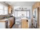 Bright eat-in kitchen features stainless appliances, wooden cabinetry, and a large bay window at 6386 S Pierson St, Littleton, CO 80127