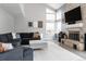 Open concept living room with high ceilings and brick fireplace at 6386 S Pierson St, Littleton, CO 80127