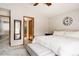 Bright main bedroom featuring neutral decor, ensuite bathroom, and large windows at 6386 S Pierson St, Littleton, CO 80127