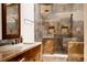 Spa-like shower with dual shower heads and decorative stone-look ceramic tile at 6386 S Pierson St, Littleton, CO 80127